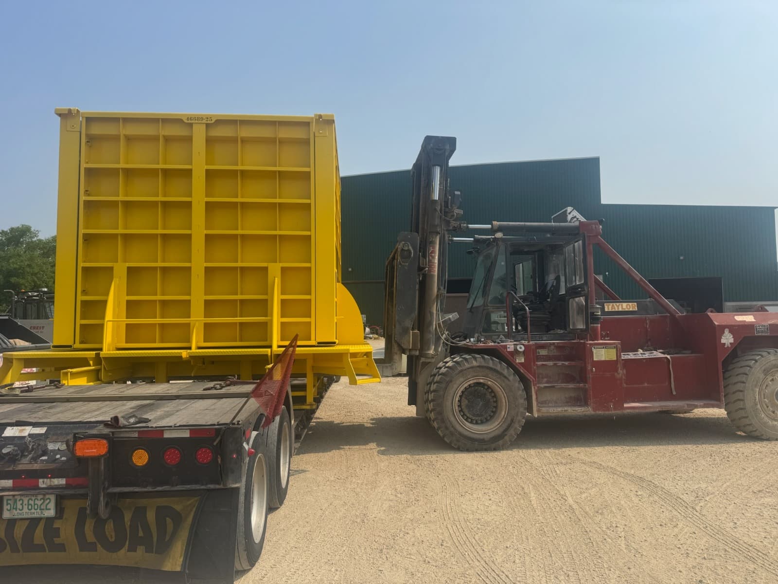 Overwidth load being loaded — the kind of move that needs accurate escort planning